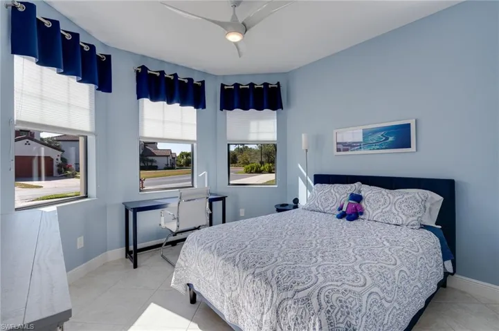 Guest Bedroom featuring upgraded ceiling fan and triple impact windows for lots of light.