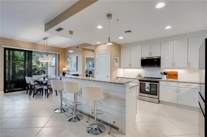 Kitchen peters, LED ceiling, lighting, upgraded backsplash, and newer Samsung Bespoke refrigerator and microwave.