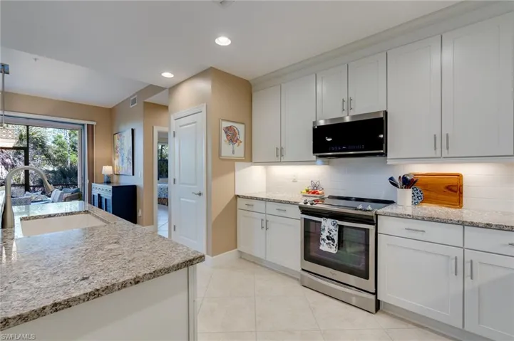 Kitchen featuring lots of light from two huge sliders.