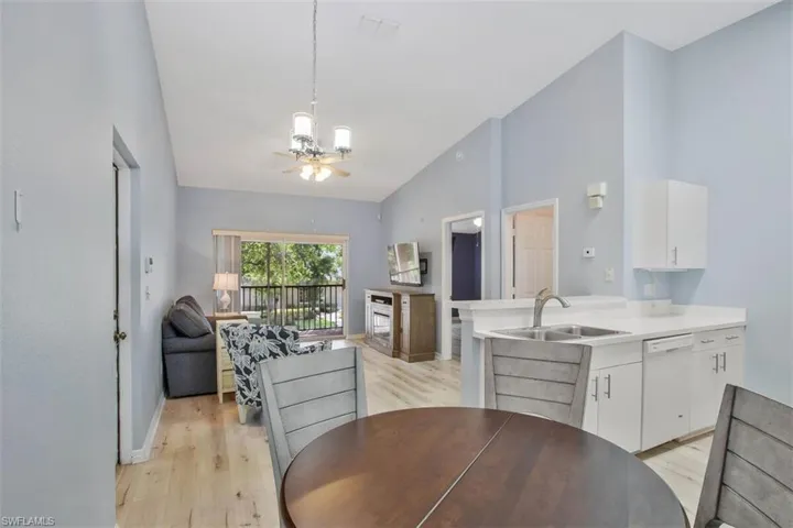Dining area with sink, ceiling fan, and light hardwood / wood-style flooring