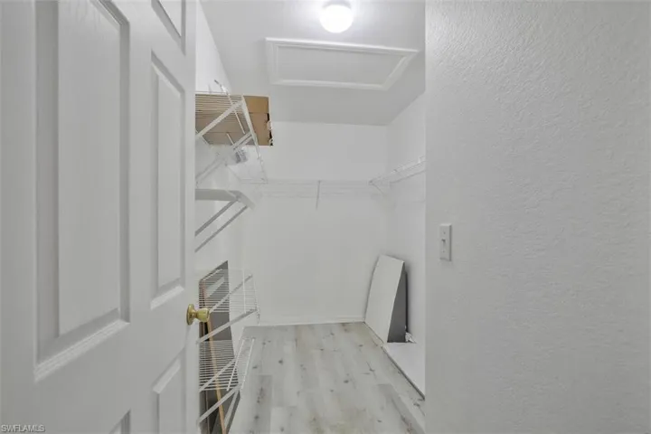 Spacious closet featuring light wood-type flooring