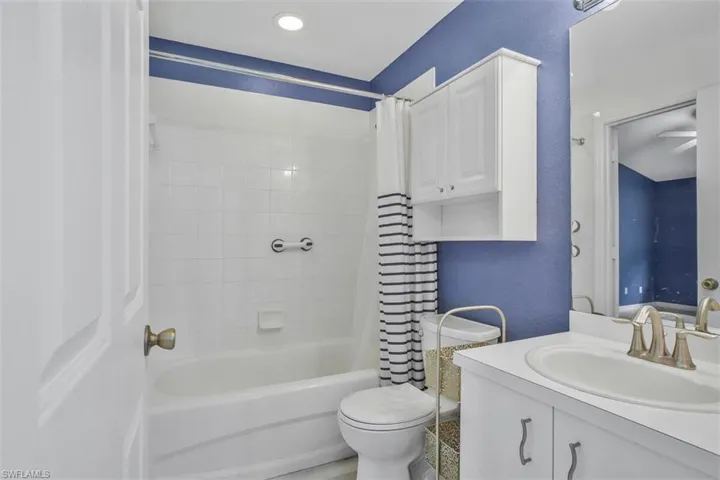Full bathroom featuring shower / tub combo, vanity, and toilet