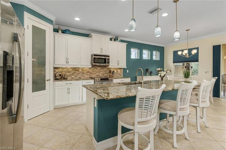 Exquisite detailing to include custom pantry door, pulls, sliders in cabinets, lighting, undermount lighting, upgraded granite and backsplash.