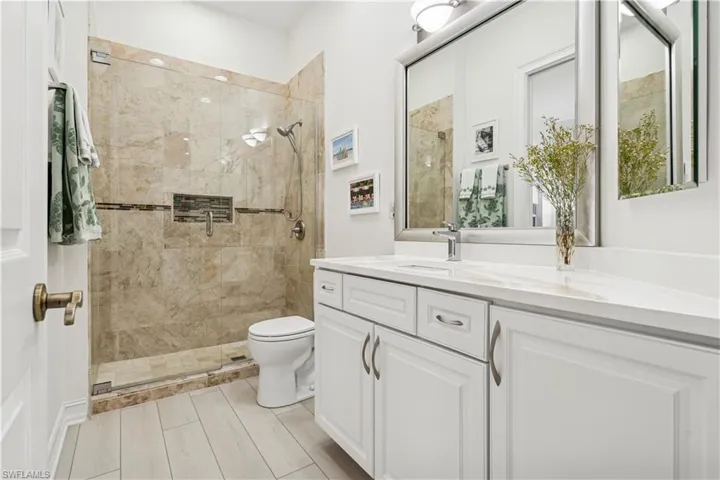 Full bathroom with vanity and a stall shower
