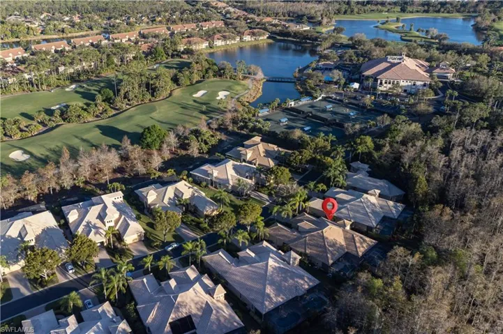 Aerial view of property and surrounding area with a large body of water and nearby suburban area