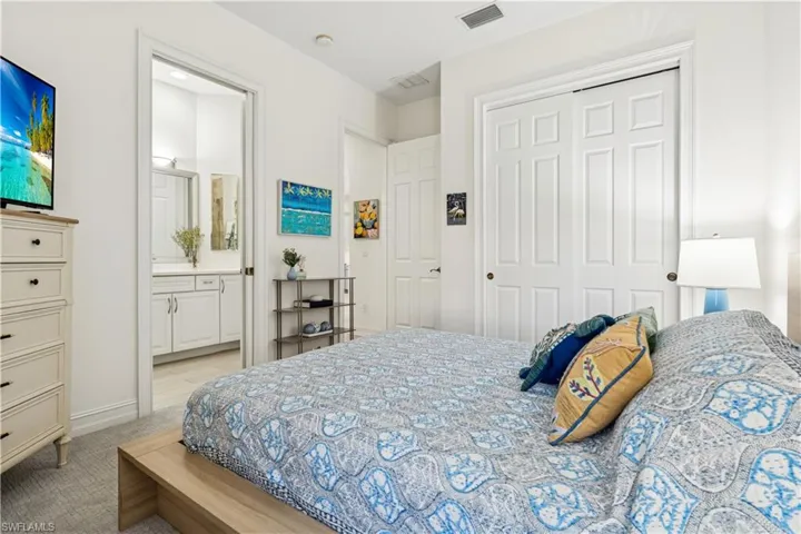 Bedroom featuring light carpet and a closet