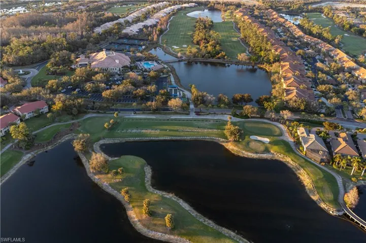 Aerial view of property's location featuring a local golf course, a nearby body of water, and nearby suburban area