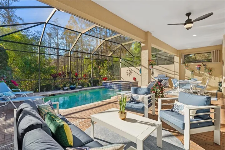 Integrated pool / spa with a patio, a sunroom, a lanai, and an outdoor living / dining area