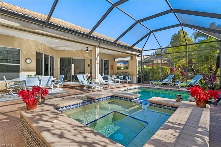 Relaxing pool / spa featuring a patio, a sunroom, an outdoor living / dining area, and a lanai