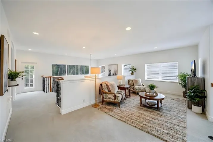 Sitting room featuring an upstairs landing, carpet floors, and recessed lighting
