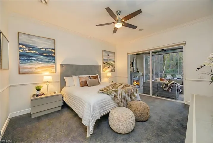 Carpeted bedroom featuring ornamental molding, access to outside, and a ceiling fan