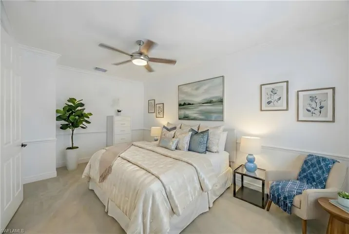 Bedroom with crown molding, carpet floors, and ceiling fan