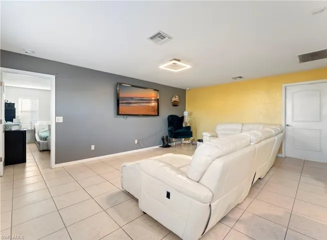 Living area featuring light tile patterned floors