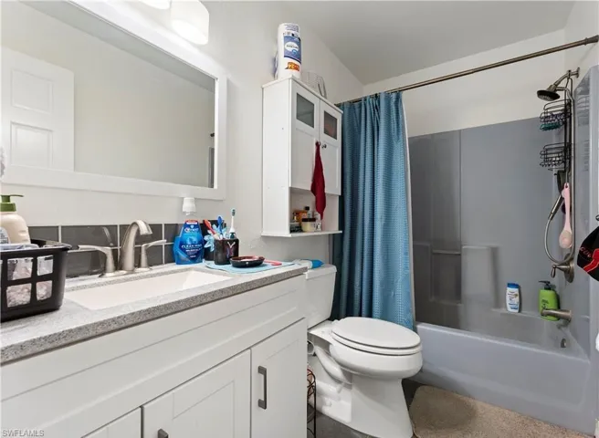 Bathroom featuring vanity and shower / bath combo