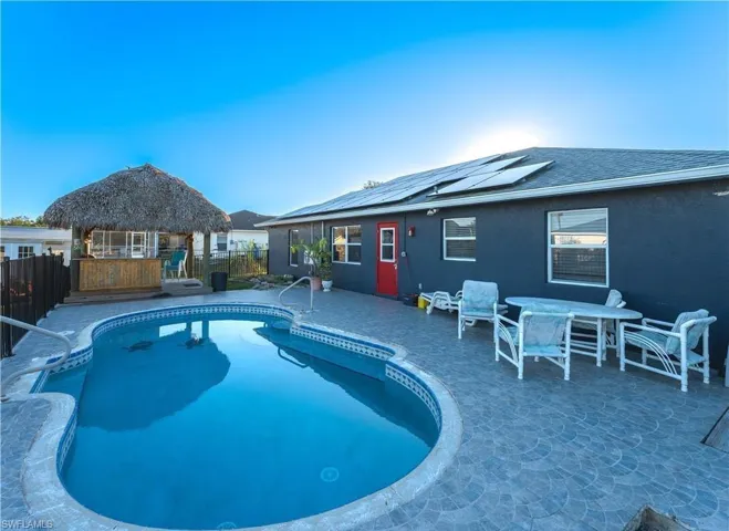 View of swimming pool featuring a gazebo, a fenced backyard, a patio area, and outdoor dining space
