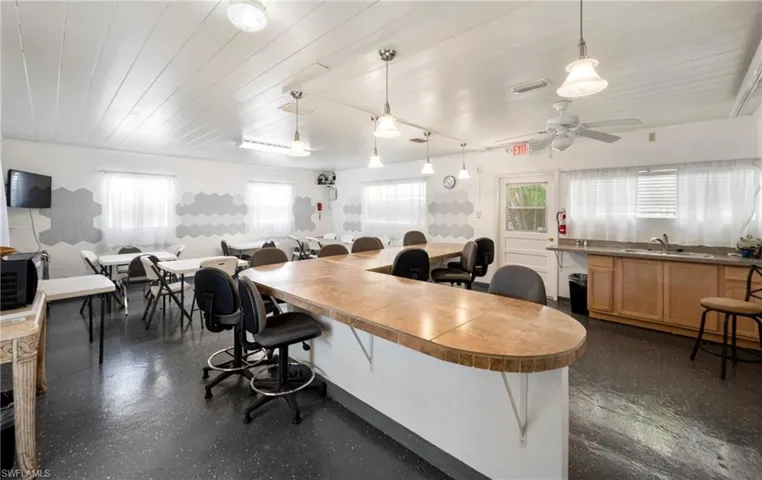 Home office with wood ceiling and a sink
