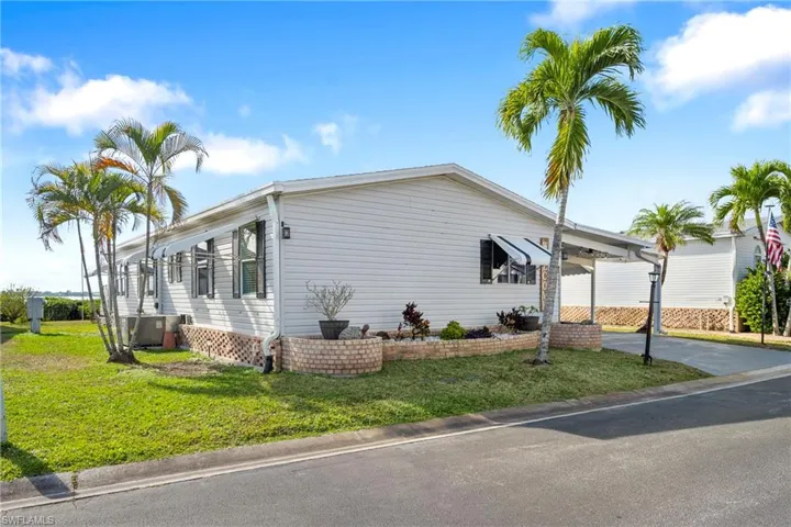 View of home's exterior with a yard and concrete driveway
