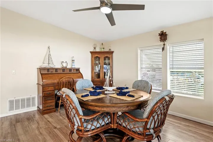 Dining area with light wood-style floors and ceiling fan