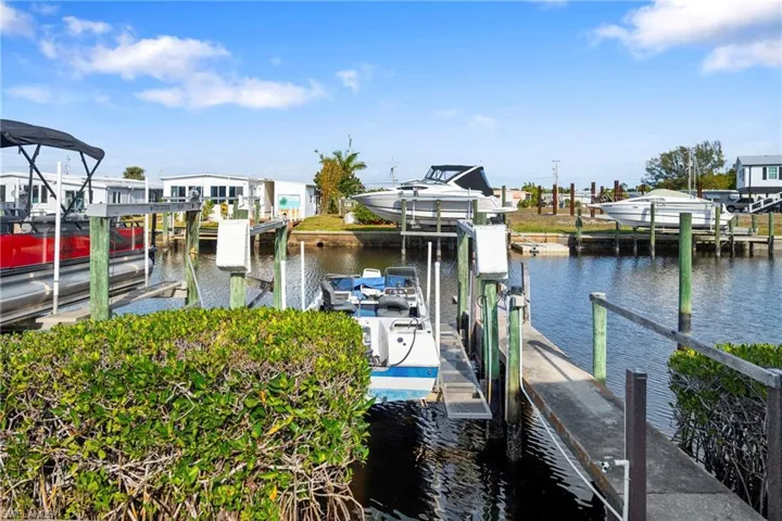 Dock area featuring boat lift and a water view