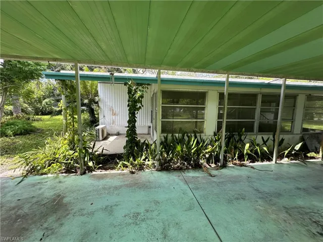 View of carport and enclosed lanai