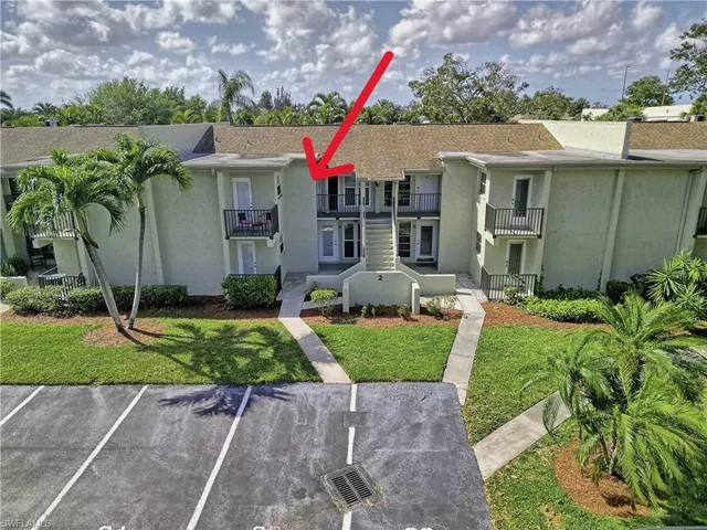 View of property featuring uncovered parking