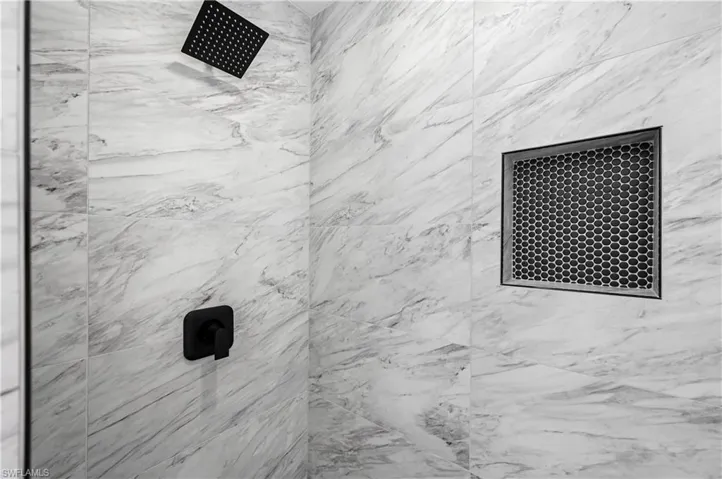 Bathroom view of a marble finish shower