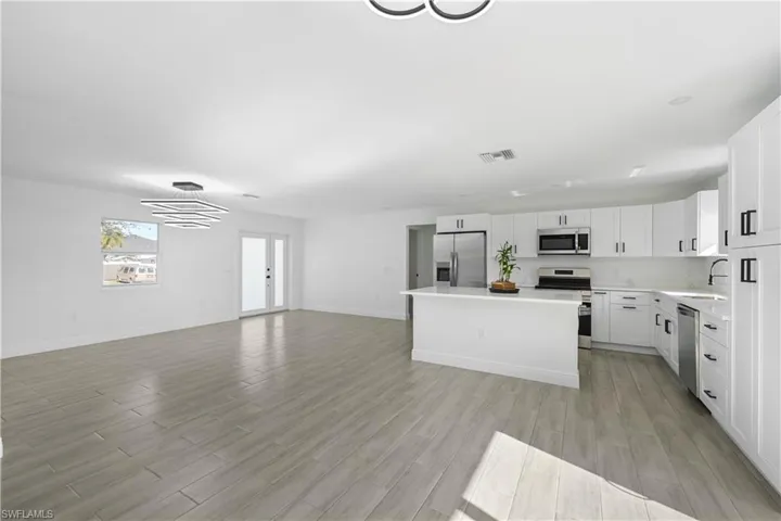 Kitchen with stainless steel appliances, stone counters