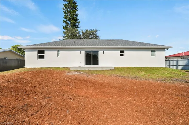 Back of house with a patio area, stucco siding
