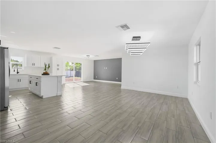 Unfurnished living room featuring wood-like tiled floors