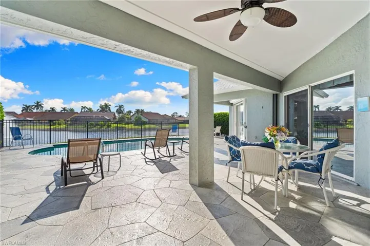 View of patio featuring a residential view, a water view, and a ceiling fan