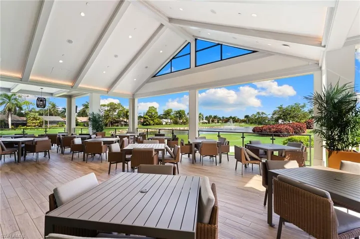 Wooden terrace with outdoor dining area and a water view