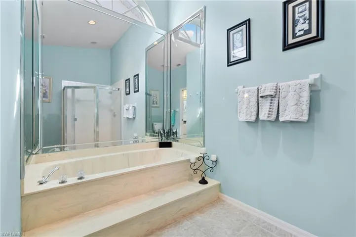 Bathroom featuring a walk in shower and tile patterned floors