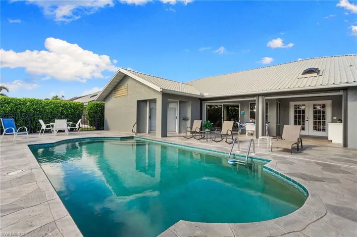 View of swimming pool with a patio area and french doors