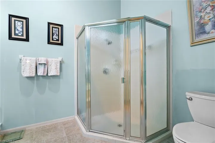 Full bath featuring a shower stall and tile patterned floors