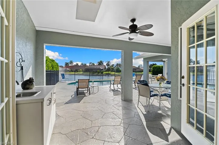View of patio / terrace featuring a ceiling fan and a water view
