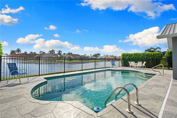 View of swimming pool with a patio, a water view, and a residential view