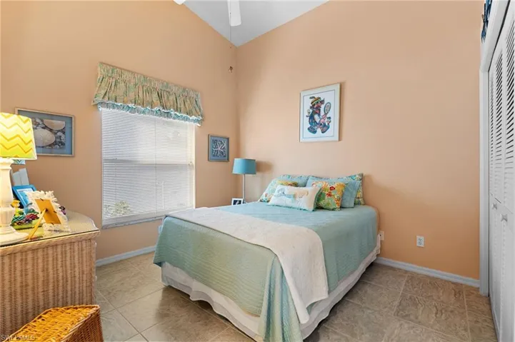 Bedroom featuring ceiling fan, a closet, and light tile patterned floors