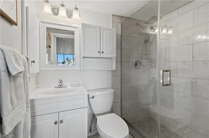 Bathroom featuring a shower stall and vanity
