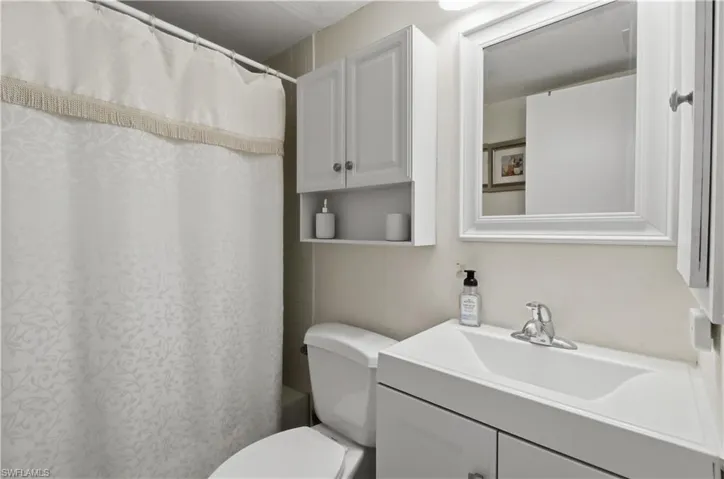 Full bath with vanity and shower / bath combo with shower curtain