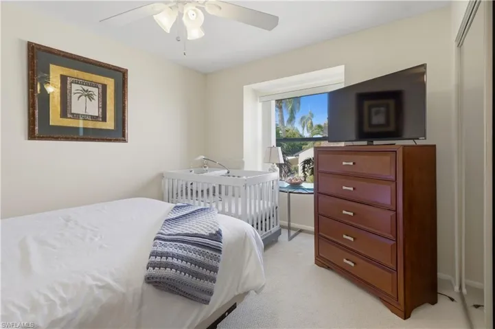 Bedroom featuring light carpet and ceiling fan