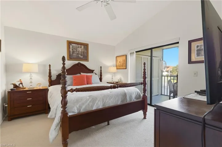 Bedroom with lofted ceiling, light colored carpet, ceiling fan, and access to outside