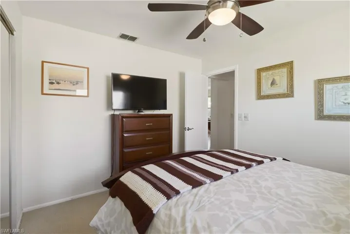 Bedroom featuring ceiling fan and light colored carpet