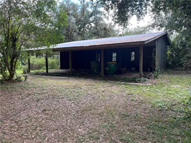 Wood-sided structure with a covered porch and a metal roof