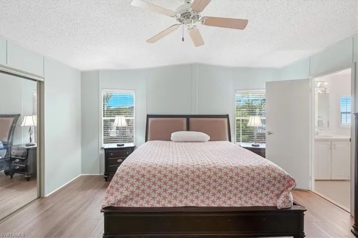 Wood-finish flooring with a ceiling fan overhead