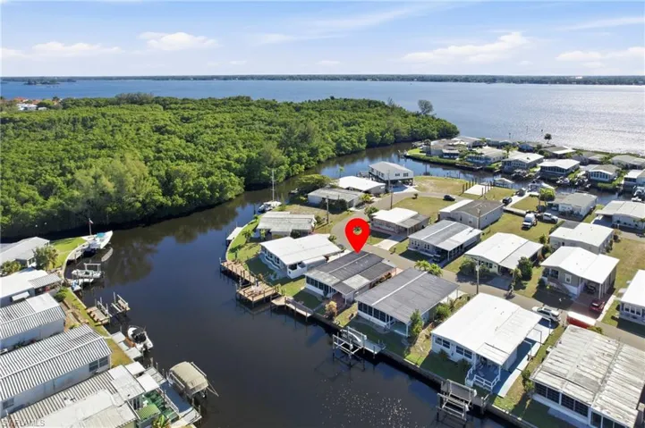 Aerial view of residential area featuring a nearby body of water