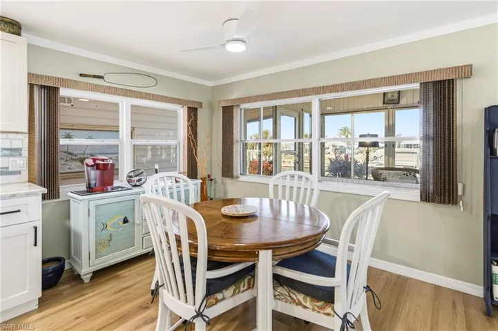 Dining area with light wood finished floors and ceiling fan