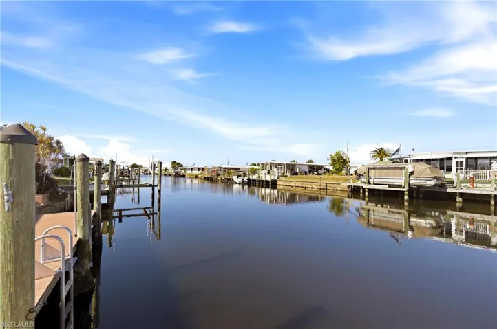 Dock area featuring a water view and boat lift