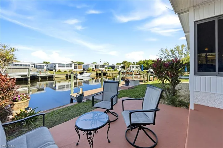 View of patio / terrace featuring a boat dock, a water view, and a residential view