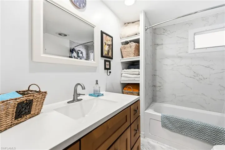 Full bathroom featuring vanity and shower / bath combo with shower curtain