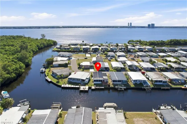 Aerial view of residential area featuring a nearby body of water